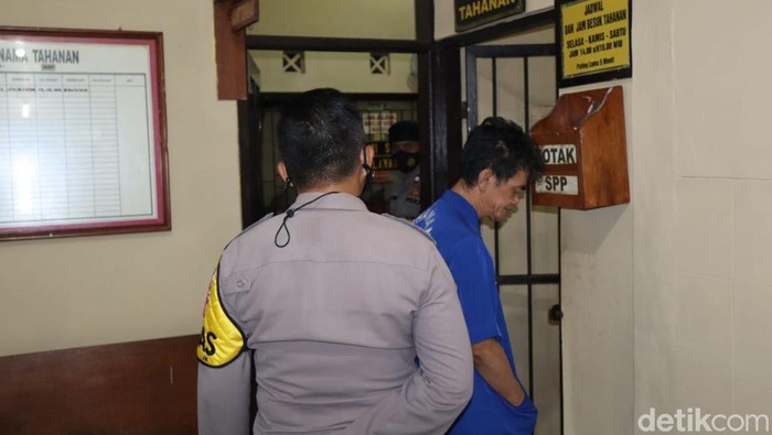 Polisi menggiring pelaku ke ruang tahanan.