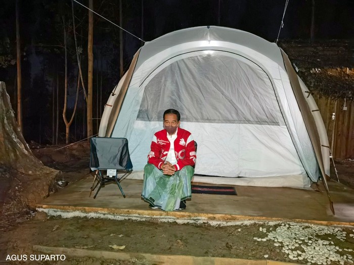 Presiden Joko Widodo (kanan) mengenaan sarung berwarna hijau dan jaket merah bertuliskan G20 saat bermalam di titik nol Ibu Kota Negara (IKN) Nusantara, Kecamatan Sepaku, Penajam Paser Utara, Kalimantan Timur, Senin (14/3/2022). Presiden bersama sejumlah menteri dan lima gubernur di Pulau Kalimantan bermalam di lokasi titik nol IKN Nusantara.