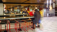 Sejumlah kecil pengunjung terlihat melalui jendela restoran McDonalds pada hari kerja terakhirnya di Lapangan Pushkinskaya di Moskow, Rusia, Senin, (14/3).