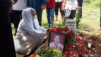 April Jasmine yang memakai pakaian serba putih terus memandangi makam sang ayah. Foto: Hanif/detikHOT
