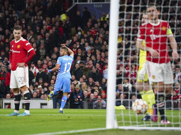 Atletico Madrid's Renan Lodi celebrates after scoring his team's first goal during the Champions League round of 16, second leg soccer match between Manchester United and Atletico Madrid at Old Trafford, Manchester, England, Tuesday, March 15, 2022. (AP Photo/Dave Thompson)