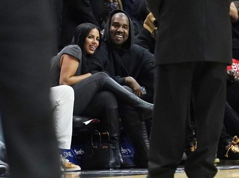 Singer Kanye West and Chaney Jones smile during a time out during the second half of an NBA basketball game between the Miami Heat and the Minnesota Timberwolves, Saturday, March 12, 2022, in Miami. (AP Photo/Marta Lavandier)