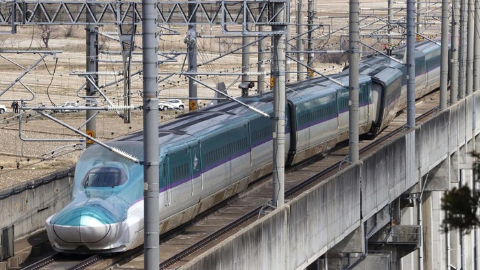 This aerial photo shows a partially derailed express train following an earthquake in Shiroishi, Miyagi prefecture, northern Japan Thursday, March 17, 2022. A powerful earthquake struck off the coast of Fukushima in northern Japan on Wednesday night, smashing furniture, knocking out power and killing some people. A small tsunami reached shore, but the low-risk advisory was lifted by Thursday morning. (Kyodo News via AP)