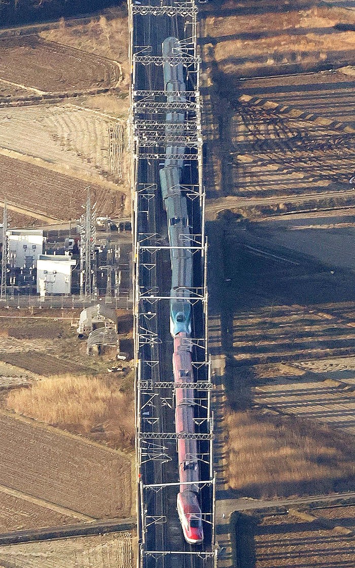 This aerial photo shows a partially derailed express train following an earthquake in Shiroishi, Miyagi prefecture, northern Japan Thursday, March 17, 2022. A powerful earthquake struck off the coast of Fukushima in northern Japan on Wednesday night, smashing furniture, knocking out power and killing some people. A small tsunami reached shore, but the low-risk advisory was lifted by Thursday morning. (Kyodo News via AP)