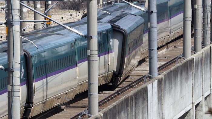 This aerial photo shows a partially derailed express train following an earthquake in Shiroishi, Miyagi prefecture, northern Japan Thursday, March 17, 2022. A powerful earthquake struck off the coast of Fukushima in northern Japan on Wednesday night, smashing furniture, knocking out power and killing some people. A small tsunami reached shore, but the low-risk advisory was lifted by Thursday morning. (Kyodo News via AP)
