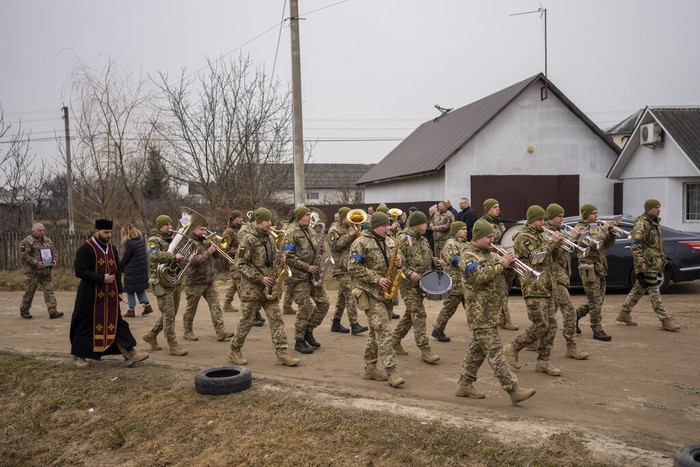 Funeral procession of Ukrainian military servicemen Roman Rak and Mykola Mykytiuk in Starychi, western Ukraine, Wednesday, March 16, 2022. Rak and Mykytiu were killed during Sunday's Russian missile strike on a military training base in Yavoriv. (AP Photo/Bernat Armangue)