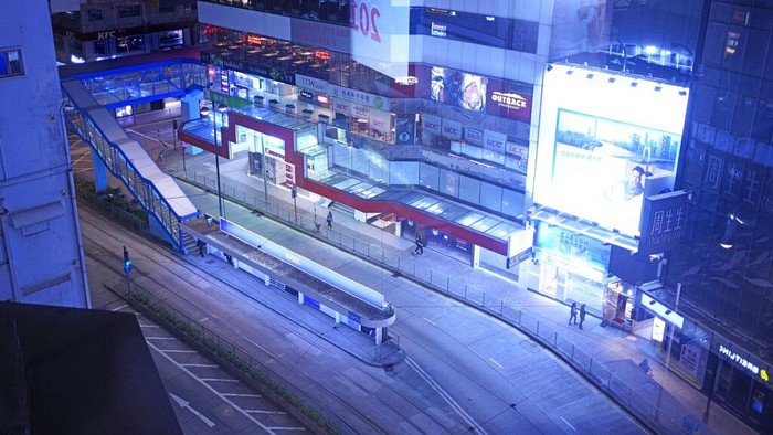 A quiet main street usually packed with shoppers is seen in Causeway Bay, a famous shopping district in Hong Kong Thursday, March 10, 2022. Hong Kong's neon lights are still on, but COVID-19 has turned off a lot of the city's usual energy. Instead, now there is an unusual sense of limbo. Busy shopping streets and office districts are very much emptier than ever before. (AP Photo/Vincent Yu)