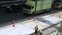 Para pekerja juga tampak sibuk menyelesaikan pengerjaan konstruksi di bahu jalan tol tersebut.