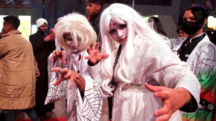 People dressed in costumes walk on a street, as they take part in a two-day costume event in Riyadh, Saudi Arabia, March 17, 2022. Picture taken March 17, 2022. REUTERS/Ahmed Yosri