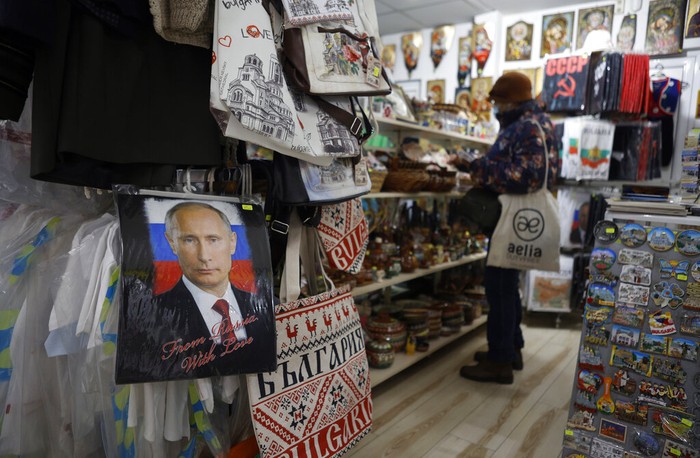A photo of Russian President Vladimir Putin is seen on a mug in a souvenir shop in Sofia , Thursday, March 17, 2022. Russian items will be removed from the shop after the war in Ukraine. escalated, says the souvenir shop seller. (AP Photo/Valentina Petrova)