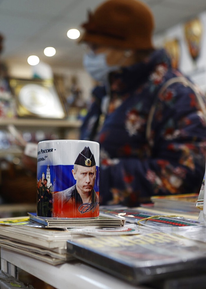 A photo of Russian President Vladimir Putin is seen on a mug in a souvenir shop in Sofia , Thursday, March 17, 2022. Russian items will be removed from the shop after the war in Ukraine. escalated, says the souvenir shop seller. (AP Photo/Valentina Petrova)