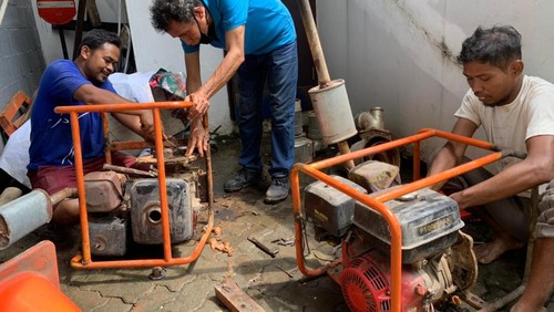 Karyawan kantor GPIB Sumber Kasih, Budi Nugroho, dan pompa air gereja yang rusak. (Mulia Budi/detikcom)