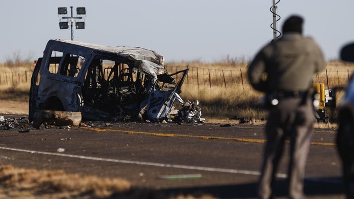 Texas Department of Public Safety Troopers look over the scene of a fatal car wreck early Wednesday, March 16, 2022 half of a mile north of State Highway 115 on Farm-to-Market Road 1788 in Andrews County, Texas. A pickup truck crossed the center line of a two-lane road in Andrews County, about 30 miles (50 kilometers) east of the New Mexico state line on Tuesday evening and crashed into a van carrying members of the University of the Southwest mens and womens golf teams, said Sgt. Steven Blanco of the Texas Department of Public Safety. (Eli Hartman/Odessa American via AP)