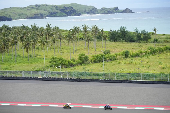 Spanish rider Marc Marquez of the Repsol Honda team, right, look to Italian rider Francesco Bagnia of Ducati Lenovo Team, left, during third free practice at Pertamina Mandalika Circuit in Mandalika, Lombok Island, Indonesia, Saturday, March 19, 2022. (AP Photo/Achmad Ibrahim)