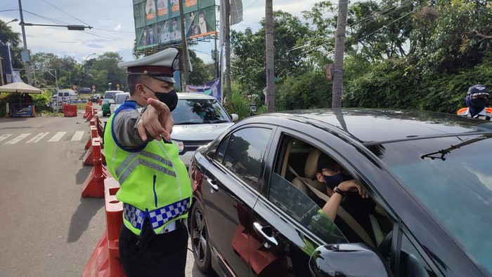 Petugas mengatur lalu lintas di Simpang Gadog, Bogor, Sabtu (18/3/2022).