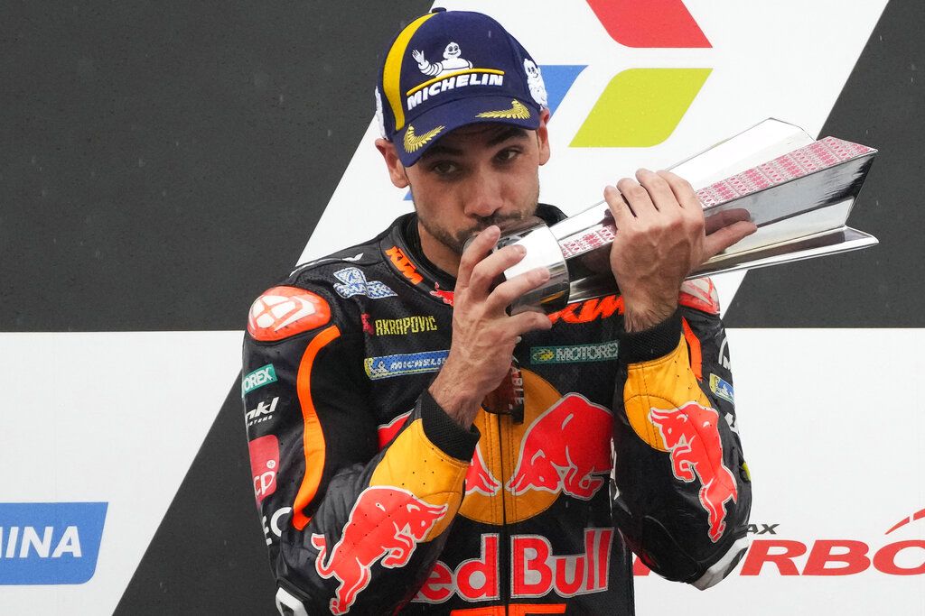 Portugal's rider Miguel Aliveira of Red Bull KTM Factory Racing celebrates victory after winning the Moto GP Pertamina Grand Prix of Indonesia at Pertamina Mandalika Circuit in Mandalika, Lombok Island, Indonesia, Sunday, March 20, 2022.(AP Photo/Achmad Ibrahim)