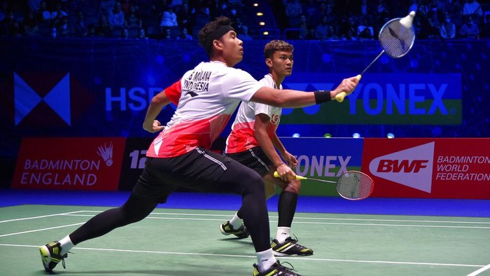 Indonesia's Muhammad Shohibul Fikri, left, and Bagas Maulana celebrate after defeating their compatriots Mohammad Ahsan and Hendra Setiawan during their men's doubles final match at the All England Open Badminton Championships in Birmingham, England, Sunday, March 20, 2022. (AP Photo/Rui Vieira)
