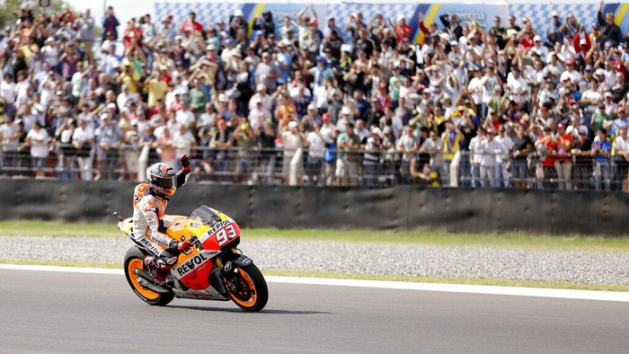 MotoGP rider Marc Marquez of Spain waves to the public after he won the pole position during qualifying for the Argentinas Motorcycle Grand Prix at the Termas de Rio Hondo circuit, Argentina, Saturday, April 26, 2014. Argentinas Motorcycle Grand Prix will take place Sunday. (AP Photo/Natacha Pisarenko)