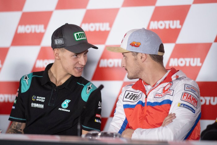 VALENCIA, SPAIN - NOVEMBER 16: Fabio Quartararo of France and Petronas Yamaha SRT speaks with Jack Miller of Australia and Pramac Racing  (R) during the press conference at the end of the qualifying practice during the MotoGP Of Valencia - Qualifying at Ricardo Tormo Circuit on November 16, 2019 in Valencia, Spain. (Photo by Mirco Lazzari gp/Getty Images)