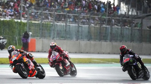 Portugals Miguel Aliveira of Red Bull KTM Factory Racing, left, leads Australian rider Jack Miller of Ducati Lenovo team, center, French rider Fabio Quartararo of Monster Energy Yamaha MotoGP, right, during Moto GP Pertamina Grand Prix of Indonesia at the Pertamina Mandalika Circuit in Mandalika, Lombok Island, Indonesia, Sunday, March 20, 2022.(AP Photo/Achmad Ibrahim)