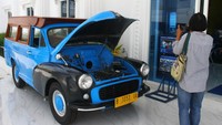 Pengunjung memotret koleksi kendaraan oplet yang pernah dipakai dalam serial televisi Si Doel Anak Sekolahan di Museum Motor Klasik SMK Nasional Media Center (NMC) Malang, Jawa Timur, Senin (21/3/2022).