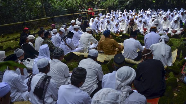 Sejumlah tokoh adat dan masyarakat berdoa di makam KH Eyang Penghulu Gusti saat tradisi adat Nyepuh di Desa Ciomas, Kecamatan Panjalu, Kabupaten Ciamis, Jawa Barat, Senin (21/3/2022).  