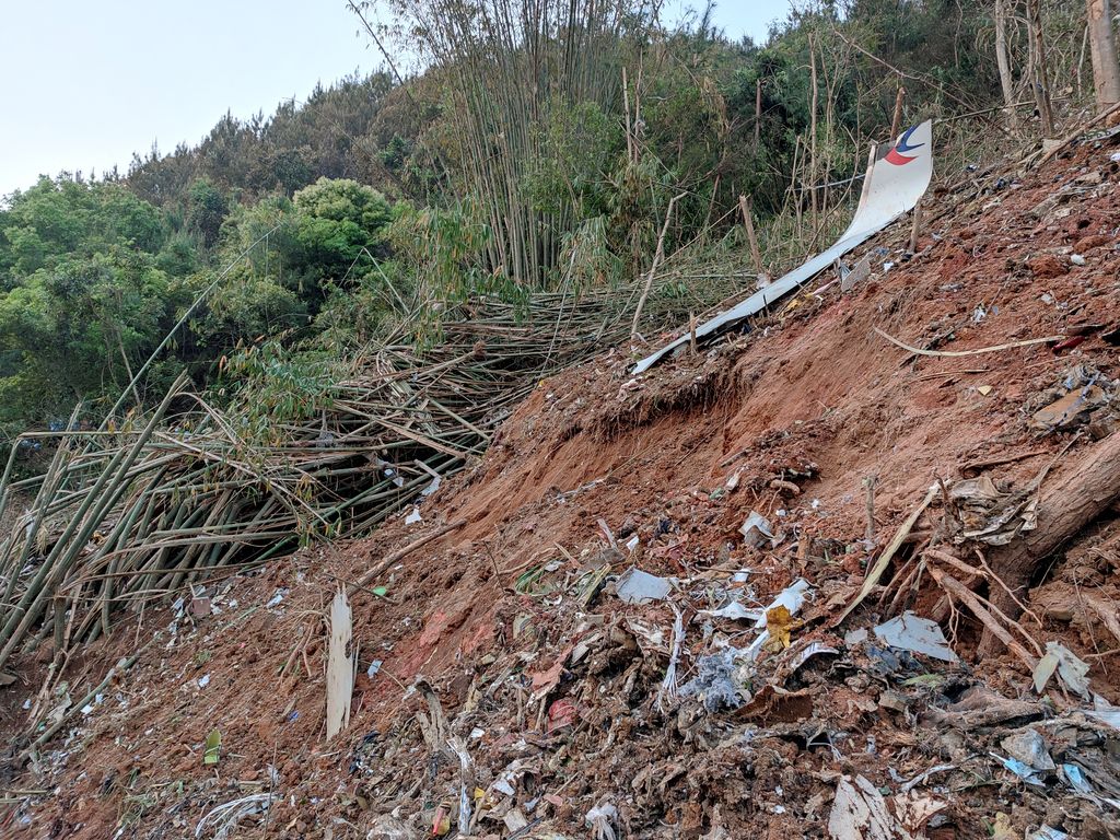 Paramilitary police officers work at the site where a China Eastern Airlines Boeing 737-800 plane flying from Kunming to Guangzhou crashed, in Wuzhou, Guangxi Zhuang Autonomous Region, China March 21, 2022. Picture taken March 21, 2022. China Daily via REUTERS  ATTENTION EDITORS - THIS IMAGE WAS PROVIDED BY A THIRD PARTY. CHINA OUT.