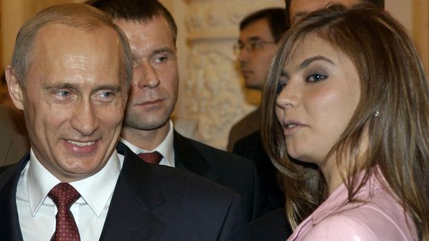 FILE - In this Thursday, Nov. 4, 2004 file photo President Vladimir Putin, left, speaks with gymnast Alina Kabaeva at a Kremlin banquet in Moscow, Russia. Alina Kabayeva, the Olympic gold gymnast whose relationship with Russian President Vladimir Putin is the subject of wide speculation, is resigning from her seat in the national parliament. Russian news reports say Kabayeva on Monday, Sept 15, 2014,  asked to step down in order to undertake other unspecified work. (AP Photo/ITAR-TASS, Presidential Press Service, File)