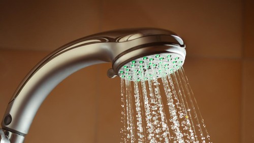 shower with flowing water and steam, closeup view