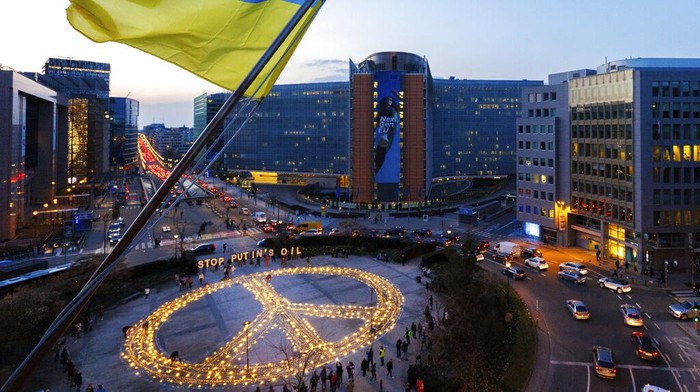 IMAGE DISTRIBUTED FOR AVAAZ - Candles and lights form a giant peace sign during the Avaaz peace vigil action in front of the European Council and Commission buildings on Tuesday, March 22, 2022 in Brussels, Belgium. Avaaz calls on Europe to get off Russian oil to stop the Ukraine war ahead of the European Council summit with US President Biden. Olivier Matthys/AP Images for Avaaz Foundation)