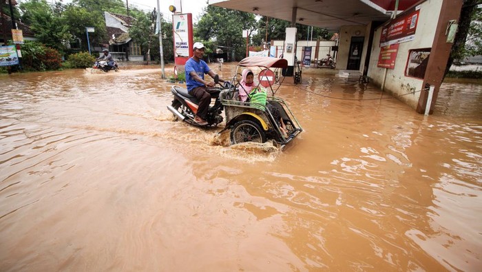 268 KK Terdampak Banjir di Pasuruan Warga beraktivitas di rumahnya yang terendam banjir di Desa Kedawung, Grati, Pasuruan, Jawa Timur, Jumat (25/3/2022). Menurut data Badan Penanggulangan Bencana Daerah (BPBD) Kabupaten Pasuruan, sebanyak 268 Kepala Keluarga (KK) terdampak banjir dengan ketinggian hingga 80 cm akibat hujan deras dan luapan Sungai Rejoso. ANTARA FOTO/Umarul Faruq/aww.