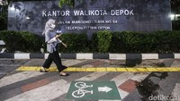 Seorang warga melintas di trotoar yang dicat kotak warna hijau bergambar sepeda di trotoar Margonda, Depok, Jawa Barat, Jumat (25/3/2022).