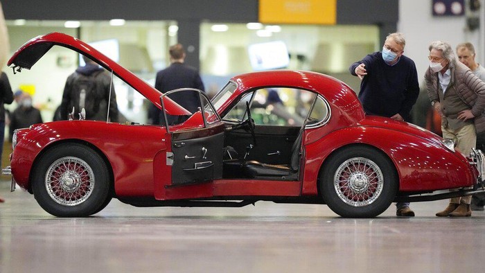 Visitors pass vintage Porsche cars at the international classic and vintage car show 