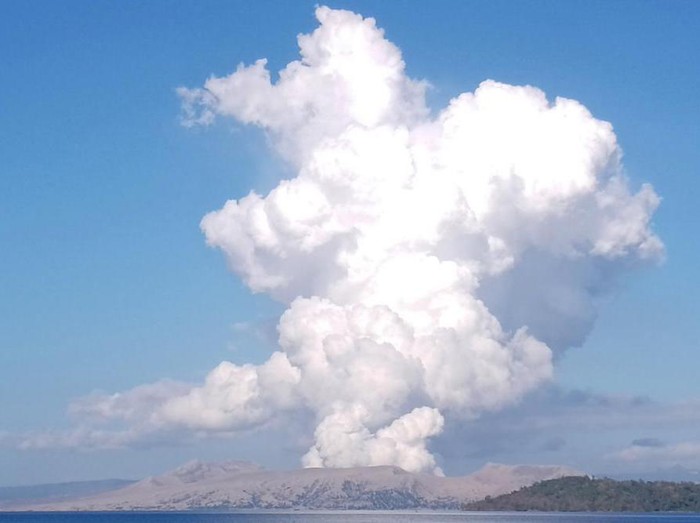 Taal Volcano spews white steam and ash as seen from Balete, Batangas province, south of Manila, Philippines on Saturday March 26, 2022. A small Philippine volcano in a scenic lake near the capital belched a white plume of steam and ash 1.5 kilometers (1 mile) into the sky in a brief explosion Saturday, prompting authorities to raise an alert level and urge thousands of residents to protectively evacuate from high-risk villages. (AP Photo/Reynante Olitan De Villa)