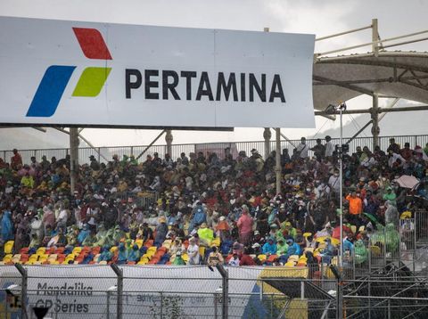 LOMBOK, INDONESIA - MARCH 20: Spectators are seen wearing raincoats during a downpour prior to the MotoGP Grand Prix of Indonesia at Mandalika International Street Circuit on March 20, 2022 in Lombok, Indonesia. The final race was postponed due to weather conditions. (Photo by Robertus Pudyanto/Getty Images)