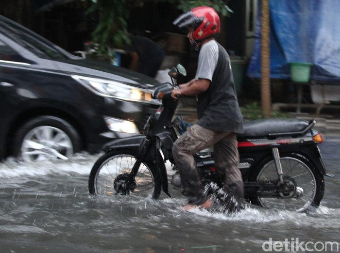 Banjir terjadi di Jalan Semarang, Surabaya. Banyak mobil dan motor yang nekat menerabas banjir, tak sedikit pula yang memilih berputar balik.