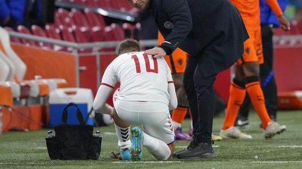 Denmark's coach Kasper Hjulmand talks to Denmark's Christian Eriksen before he enters the pitch as substitute during the international friendly soccer match between the Netherlands and Denmark at the Johan Cruyff ArenA in Amsterdam, Netherlands, Saturday, March 26, 2022. The match was Eriksen's first appearance for Denmark since he collapsed after suffering a cardiac arrest during a European Championship game in June. (AP Photo/Peter Dejong)
