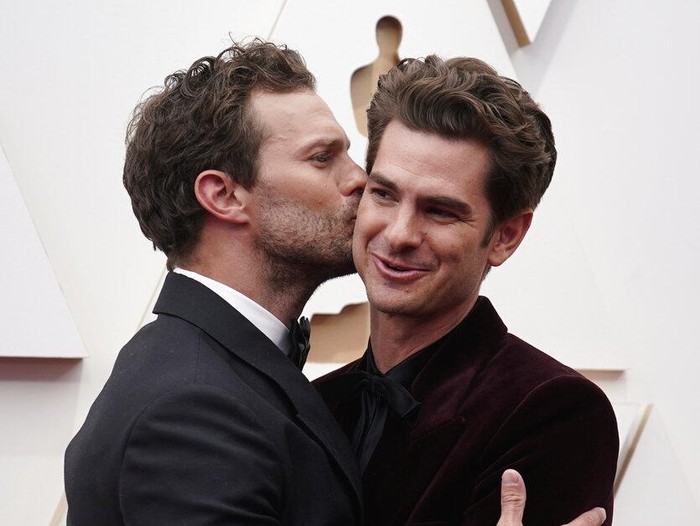 Jamie Dornan, left, and Andrew Garfield arrive at the Oscars on Sunday, March 27, 2022, at the Dolby Theatre in Los Angeles. (AP Photo/Jae C. Hong)