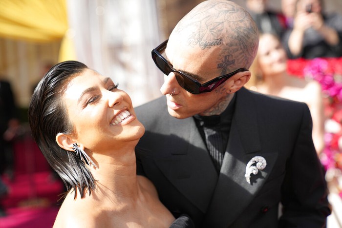 Kourtney Kardashian, left, and Travis Barker arrive at the Oscars on Sunday, March 27, 2022, at the Dolby Theatre in Los Angeles. (AP Photo/John Locher)
