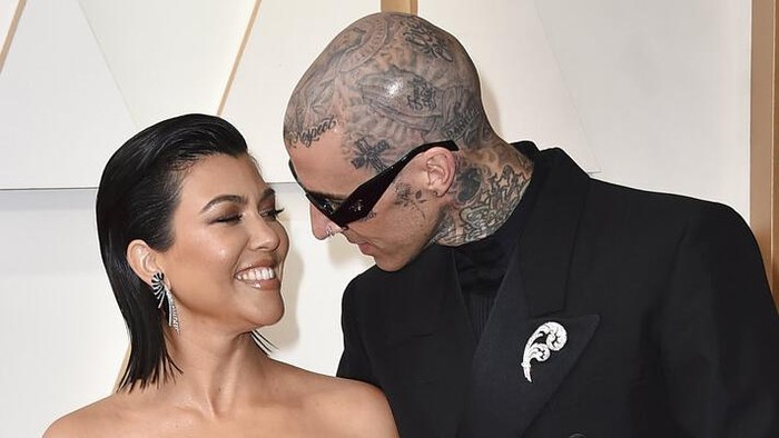 Kourtney Kardashian, left, and Travis Barker arrive at the Oscars on Sunday, March 27, 2022, at the Dolby Theatre in Los Angeles. (Photo by Jordan Strauss/Invision/AP)