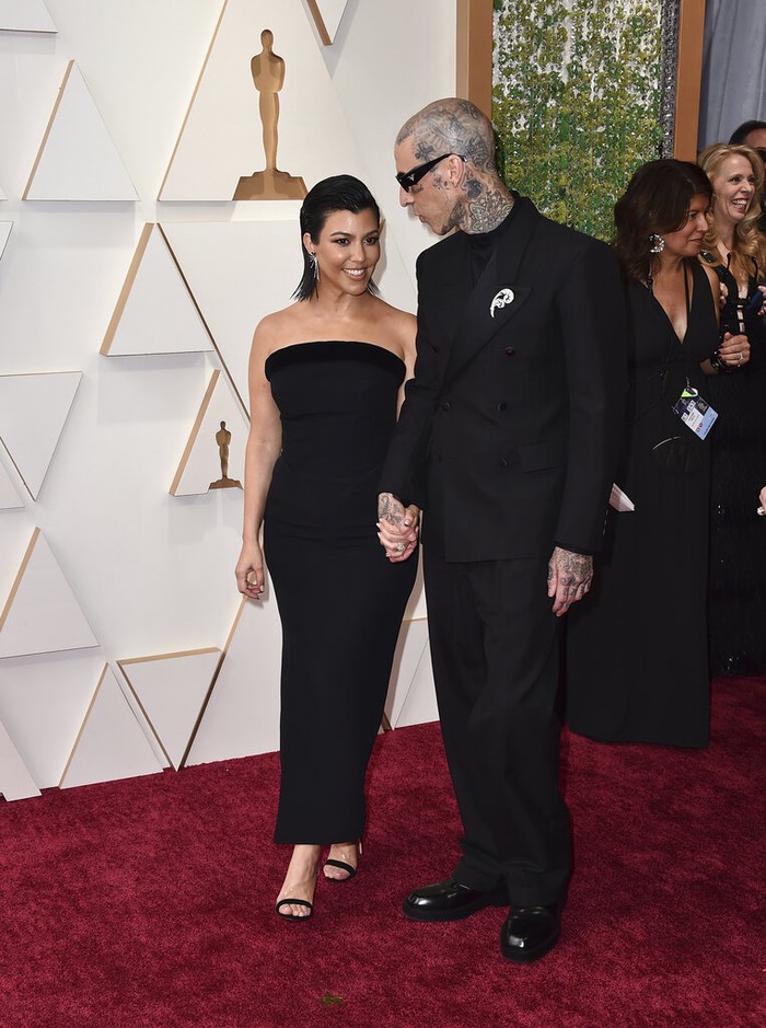 Kourtney Kardashian, left, and Travis Barker arrive at the Oscars on Sunday, March 27, 2022, at the Dolby Theatre in Los Angeles. (Photo by Jordan Strauss/Invision/AP)