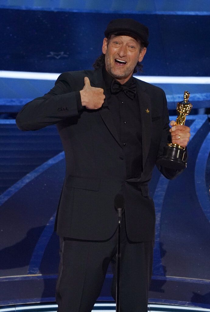 Troy Kotsur accepts the award for best performance by an actor in a supporting role for 
