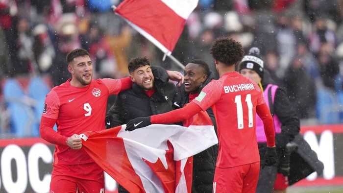 Fans cheer and wave Canadian flags before a Canada against Jamaica CONCACAF World Cup soccer qualifying match in Toronto, Sunday, March 27, 2022. (Nathan Denette/The Canadian Press via AP)