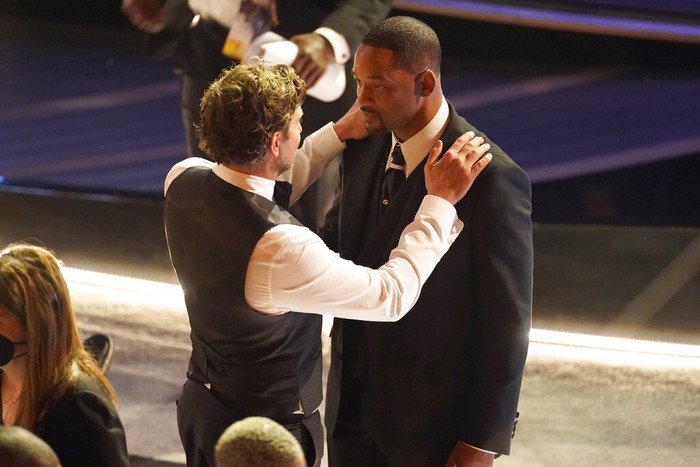 Will Smith Bradley Cooper, left, and Will Smith appear in the audience at the Oscars on Sunday, March 27, 2022, at the Dolby Theatre in Los Angeles. (AP Photo/Chris Pizzello)