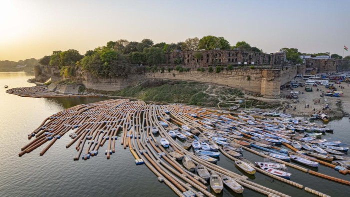 Boats stand parked by Akbar Fort on the Yamuna river in Prayagraj, India, Monday, March 28, 2022. The river is considered sacred by Hindus. (AP Photo/ Rajesh Kumar Singh)