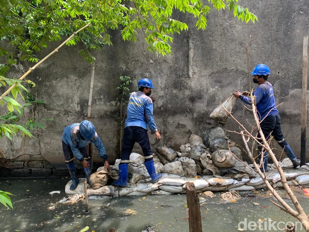 Pasukan biru membangun saluran air dan kisdam di dekat permukiman Jl Haji Dogol, Pondok Bambu, Duren Sawit, Jakarta Timur, 29 Maret 2022. (Mulia Budi/detikcom)