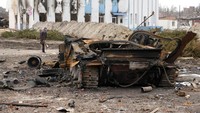 Warga melihat bangkai tank Rusia di Trostsyanets, 400 km sebelah timur Ibu Kota Kyiv, Ukraina, Senin (28/3/2022). (AP Photo/Efrem Lukatsky)