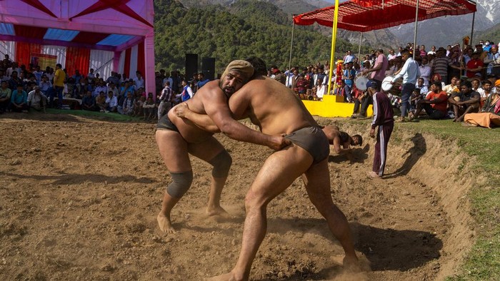 Wrestlers compete for a cash prize at a local fair in Dharmsala, India, Tuesday, March 29, 2022. These local fairs, once an annual feature, are slowly returning after being cancelled during the COVID-19 pandemic. (AP Photo/Ashwini Bhatia)