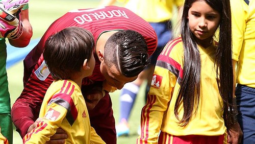 BRASILIA, BRAZIL - JUNE 26: Cristiano Ronaldo of Portugal speaks to a player escort prior to the 2014 FIFA World Cup Brazil Group G match between Portugal and Ghana at Estadio Nacional on June 26, 2014 in Brasilia, Brazil.  (Photo by Adam Pretty/Getty Images)