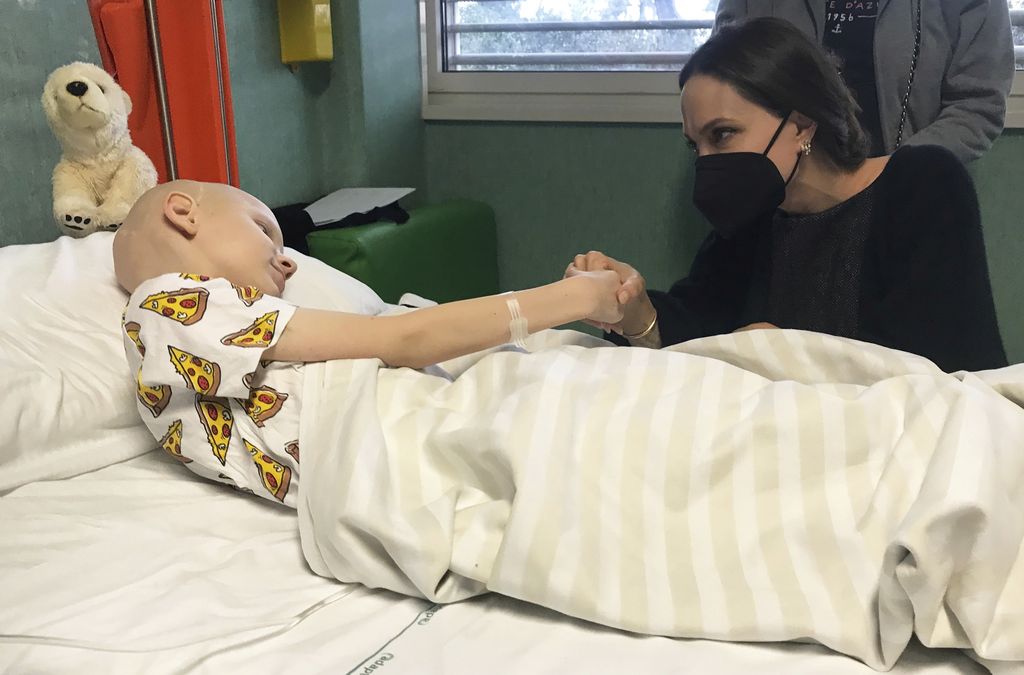 In this picture made available by the Ospedale Pediatrico Bambino Gesu on Thursday, March 31, 2022, actress Angelina Jolie, right, visits a young patient from Ukraine on Wednesday, March 30, 2022, in the Bambino Gesu pediatric hospital in Rome. Jolie made a personal visit to the Vatican's children hospital to meet the Ukrainian children who arrived in Italy due to the conflict between Ukraine and Russia, the doctors and nurses who take care of them. (Ospedale Pediatrico Bambino Gesu via AP)